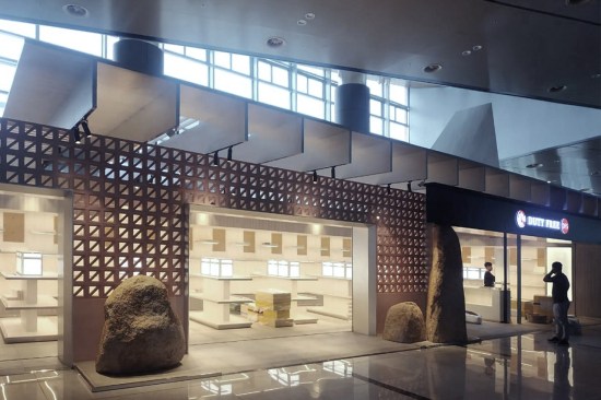 DFS, a new retail pavilion in the Van Don International Airport in Vietnam, features a transparent façade that allows travelers to glimpse the beauty products on display inside.
