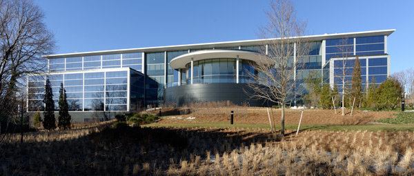 Aligned with the main entrance across the courtyard is a semi-elliptical 350-seat auditorium and event space (seen here from the rear of the building). 