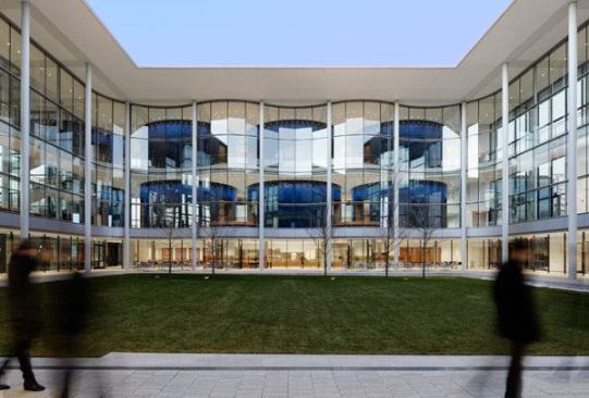 On the ground floor, these drum-like elements house a coffee shop and commons. On two double-height upper levels, they enclose 16 generously scaled classrooms.