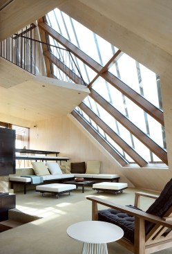 CLT supports and aluminum mullions frame a large window on the northwest fa&ccedil;ade. “At night it’s a beautiful place to look at the stars,” Koehler says. “It’s like a glass roof, so you get the feeling you’re sitting outside.”