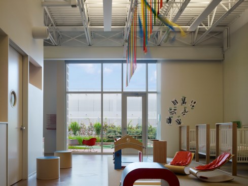 Universal classroom with ceiling ribbons that move with the mechanical air flow. Note doorway to outdoor play area