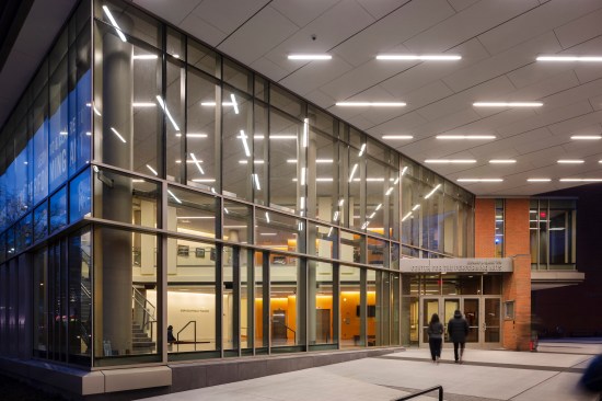 The glass curtain wall at the entry communicates the energy of the activities within.