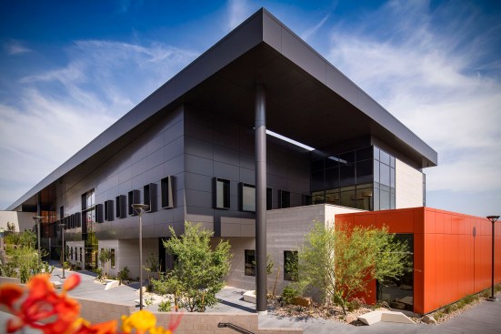The building takes advantage of the existing site slope, creating carved out 
outdoor spaces, that become cooler areas of respite for faculty and students while responding to the overall campus master plan.