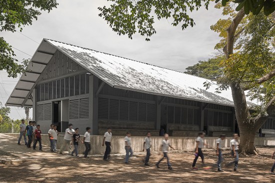 For Escuelita Buganvilia, the firm opted to contrast the local vernacular of the rural Guatemalan surroundings by using concrete and steel rather than traditional stone and wood for its construction. Completed in 2015, the 3,200-square-foot structure features five classrooms, a metal gable roof with generous eaves to protect students from inclement weather, and outdoor concrete seating that offers an informal meeting area.