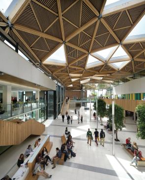 Natural light pours in through triangular 
bays filled with EFTE rooflights by London-based Vector Foiltec, chosen 
because they are lighter than conventional double glazing. Each 48 
square feet EFTE light consists of a three-layer cushion with a random 
printed frit pattern. Double-glazed windows cover the triangular 
openings in teaching and study areas to reduce rain noise.
“We originally envisioned more glass, but we ended up with half the 
number of light bays based on daylight modeling,” Critchlow says. “You 
can have too much light, especially when students are working on 
computers.”