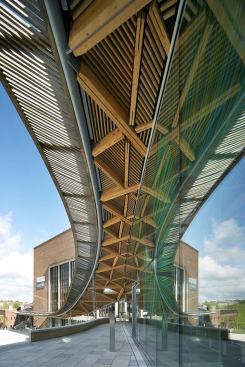 Weathered, green-oak slats give the sun 
screen along the outer rim a feathery, natural look. The slats tie in to
 steel T-sections welded onto a 7.5-inch-diameter perimeter tube.