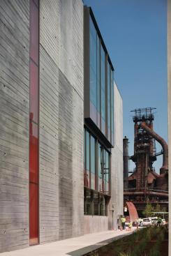 The east fa?ade is clad largely in precast concrete wall panels with a hand-screed finish.
