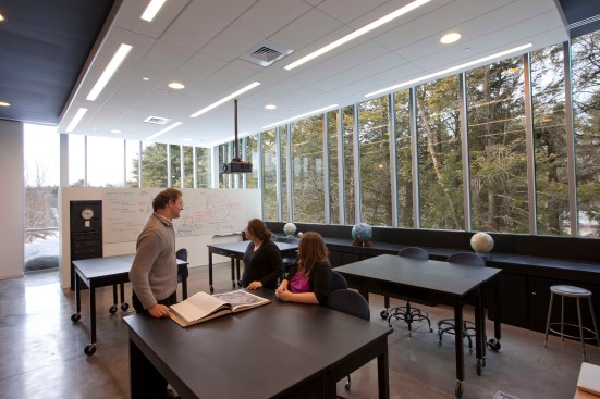 Environmental studies students and their professor in the lab. The large windows provide views into the campus's Arboretum. 