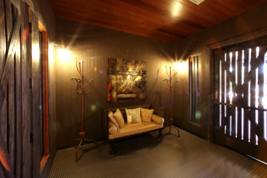 Light filtering between verticle planks is reminiscent of historic barns & sheds.