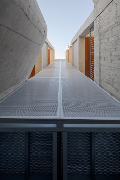 A translucent staircase with perforated screens at the building’s spine allows light and air to penetrate the spaces within. 