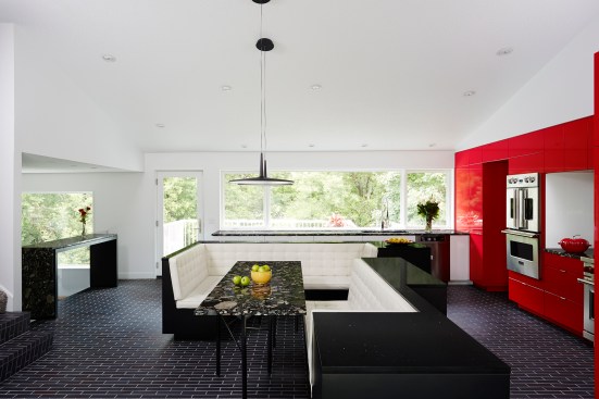 The design of the Gathering Kitchen resulted from the owner’s desire to update their kitchen and integrate underutilized dining room space. Highlights include a six-legged Marinace granite table, cherry red cabinets, and manganese ironspot brick flooring.