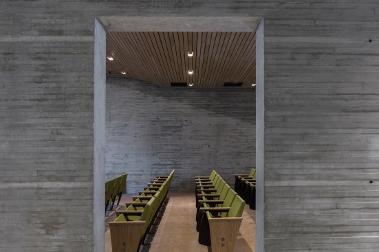 First-floor auditorium with board-formed concrete walls