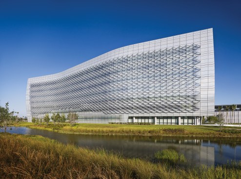 South fritted glass facade with restored wetlands in foreground