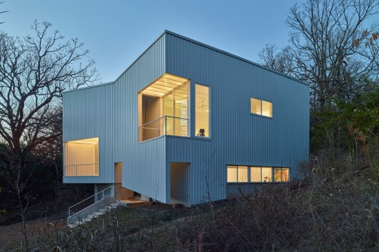 Completed in 2017, the Fayetteville, Ark., Hillside Rock residence features a corrugated metal envelope that contrasts with the landscape and the wood interior details.