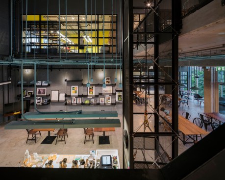 View over lower-level café, seating area, and terrace, and into upper-level jewelry and textile studio