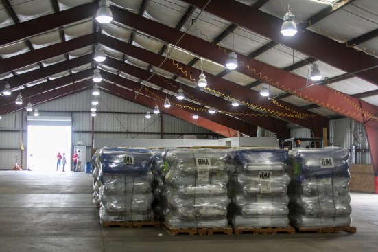 Rolls of fiber-reinforced plastic tarps arrive for distribution to contractors hired by the U.S. Army Corps of Engineers to install on the roofs of houses damaged by Hurricane Irma.