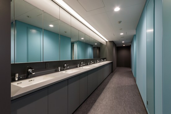 Residents of the multiple-occupancy dorms on the third, fourth, and fifth floors share communal bathrooms at the building’s center.