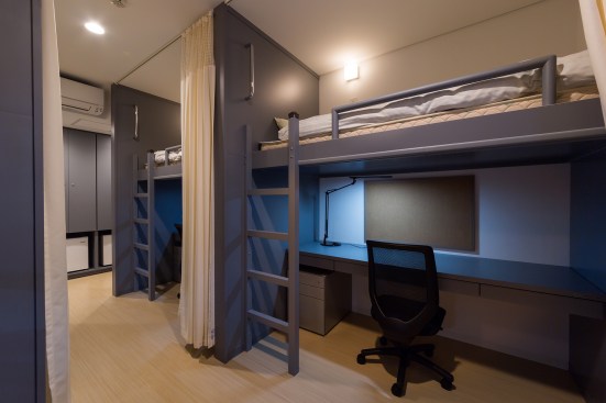 The four-person dorm rooms on the upper three floors contain loft beds with desks below.