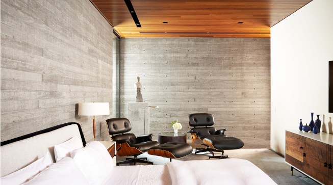 The concrete walls are left exposed throughout, including in the master bedroom of the four-bedroom, four-and-a-half-bath main house.