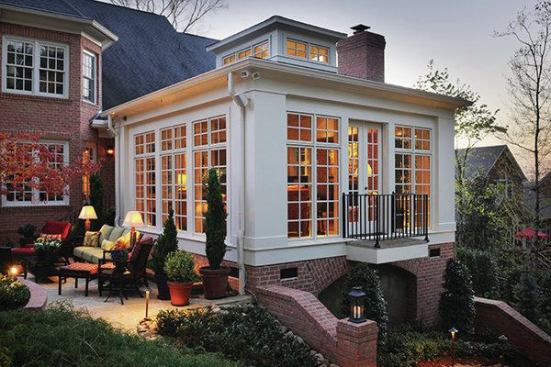 The sunroom opens onto a terrace which provides a connection to the outdoors and beautiful views of the surrounding landscape.