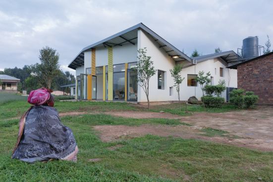 The Butaro Cancer Center's butterfly roof, topped by metal material from Tolirwa, contains concealed gutters that funnel rainwater into cisterns for use elsewhere 

on the site.