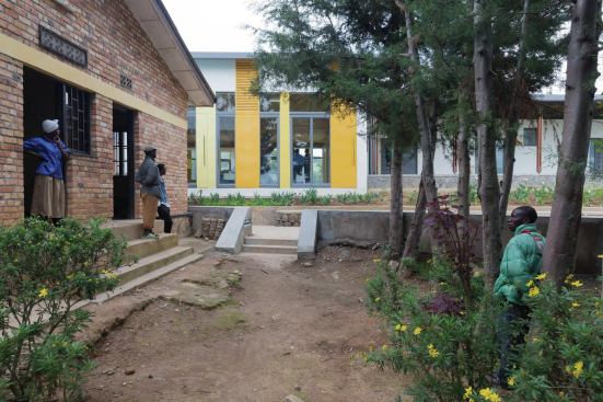 A view into the infusion room, past one of the existing buildings on the hospital campus.