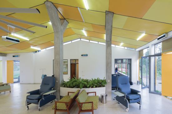 Infusion room, with a view to the outdoor colonnade and the offices and private consultation rooms.