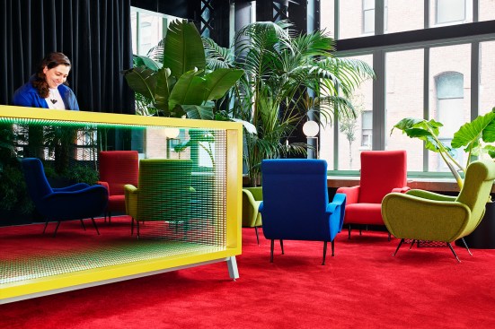 The custom furniture pieces include a reception desk with an infinity mirror in the lobby.