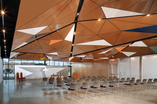Once an industrial warehouse, the sanctuary of the North Presbyterian Church in Cleveland is capped with a hybrid canopy/cathedral ceiling made of patterned panels.