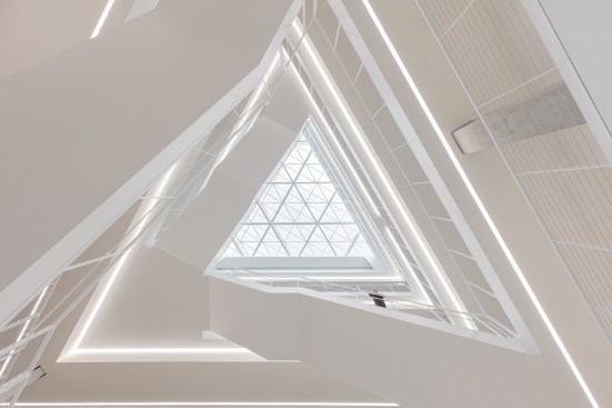 Recessed lensed lines of light reinforce the triangular concept of the building in addition to provide
the required light at the atrium.