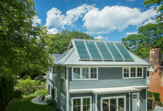 The standing seam metal roof, sloped at two different angles, supports PV and thermal solar panels, helping this home achieve LEED Platinum certification.