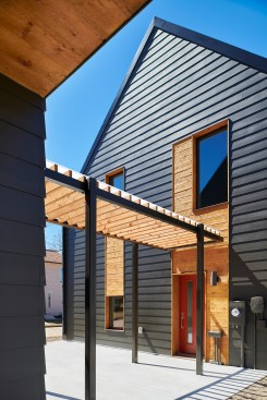 An exterior courtyard in the middle of the site bridges the gap between the residential structure and the detached garage. The envelope on both structures is kept tight with Alpen Windows and Therma-Tru doors.