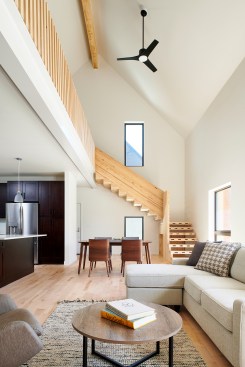 A stair made from cross-laminated timber and solid glulam rises up from the first-floor living area and provides an indoor focal point. 