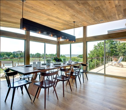 Remodeler Stephen
Breitenbach’s crew went to great lengths to ensure that there would be no roof leaks
when marrying the living room’s existing post-and-beam structure with the
new addition, which includes the nearby dining room. Above the dining table hangs the custom-made perforated-steel light fixture.