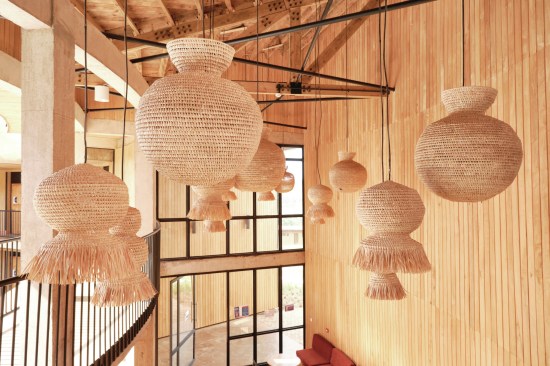 Rwanda Institute for Conservation Agriculture Interior image: Furniture and light fixtures made from natural fibers including papyrus, banana, sisal, and palm celebrate the traditions of weaving.