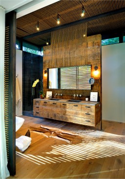The
new bathroom cabinetry is also made of refurbished wood, with the large mirror
hanging from the natural rope.