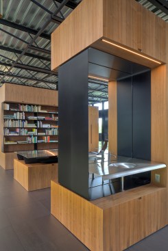 Walnut cabinets divide spaces in the largely open-plan second floor, and provide shelving for the second-floor library.