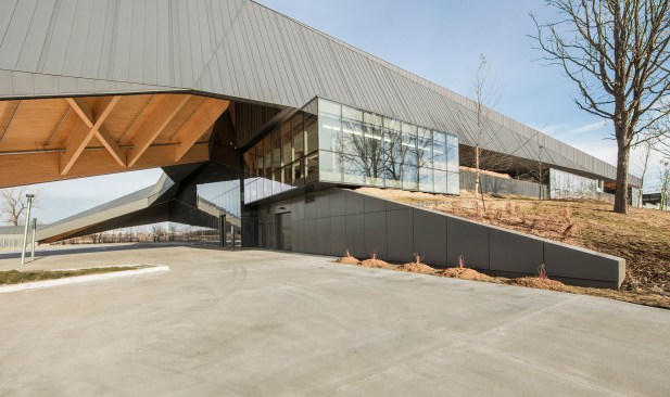Multipurpose space at southwest corner, with a view of the roof’s underside as it folds down to form seating for outdoor field