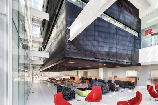 A lounge at the top of the main staircase is the first “non-programmed space” that visitors encounter in the building, and it sets the tone for the interior strategy. 