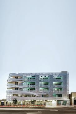 The walls of the recessed balconies are painted aquamarine. 