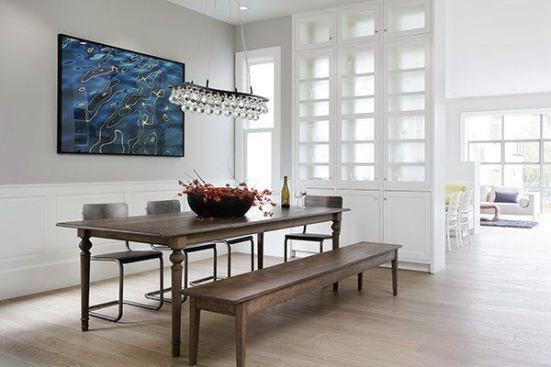 The dining room, near the front of the house, offers an open view toward the breakfast nook and family room in the rear. The interior design was done by Lisa Lougee Interiors.