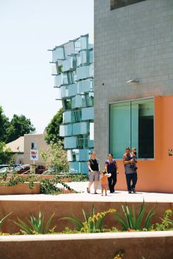 A family walks through the community plaza in front of the new Hollenbeck Police Station, in the Boyle Heights neighborhood of East Los Angeles.
