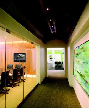 Clean lines and an elegant, but neutral palette define the aesthetic of Lucifer Lighting's new headquarters. Natural light reaches all parts of the building including the reception area and the break room. An extensive art collection is showcased throughout the facility, and the ceiling treatment of the corridor adjacent to the main conference room recalls the architectural form of architect Louis I. Kahn's Kimball Art Museum. The main conference room is equipped for numerous lighting scenarios. Skylights, coupled with high-bay fixtures provide an abundance of light in the factory.