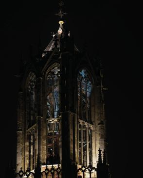 The installation culminates in a flickering burst of light from the tower's belfry.