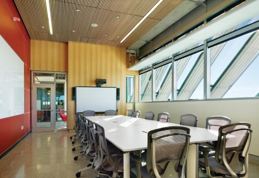 Glazed walls in the classrooms allow views of the building’s shading system, including diagonal aluminum fins on the east and west façades. 