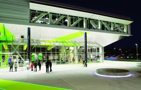 The windows that penetrate the metal siding over the entrance belong to the club lounge. Located at the southwest corner, the lounge has expansive windows that offer a view of Mount Rainier. Natural light from the windows reaches into the bowl, but during events, shutters made from airplane hangar doors block the light. Also on this second level are VIP suites, crucial to the ShoWare Center’s financial model, that run the length of the ice sheet on either side.