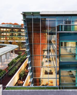 The triple-glazed curtain wall was engineered to maximize energy savings, and includes a graduated frit pattern to help mitigate glare. On the skylight and at the top of the atrium façade, the frit pattern covers 60 percent of the glass, fading to 40, then 20, and finally into clear vision glass. The articulated shape of the spine's curtain wall (which juts out at the top and tapers down to meet the base) was calculated to help minimize glare, heat gain, and also bird strikes, an important consideration in the wooded area says design partner Bruce Fowle.