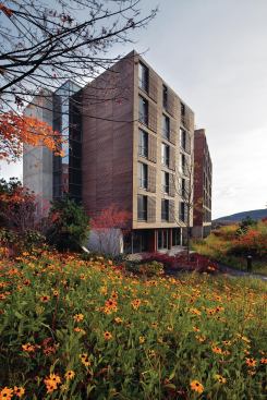 Located in the Berkshires, the new dormitory building at the Kripalu Center for Yoga & Health is a study in wood, glass, and concrete. Cypress cladding runs the length of the fa&ccedil;ade, and matching strips are worked into manually operated window shades for each guest room.