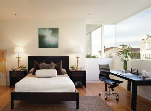 A folded street-front façade allows this guest room window to wrap a corner.