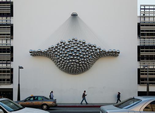 Cradle was installed last July on the side of a Frank Gehry–designed parking structure in Santa Monica. Ball and Nogues hoped that the aggregation of mirrored stainless steel spheres would stimulate "creative associations with other things in that particular [Santa Monica] environment," Ball says. "On the one hand, it's glitzy and shiny, to comment on the culture of Santa Monica, and it's shaped like a men's Speedo swimsuit. It kind of looks like sea foam. It's got all these oceanic and beach references."